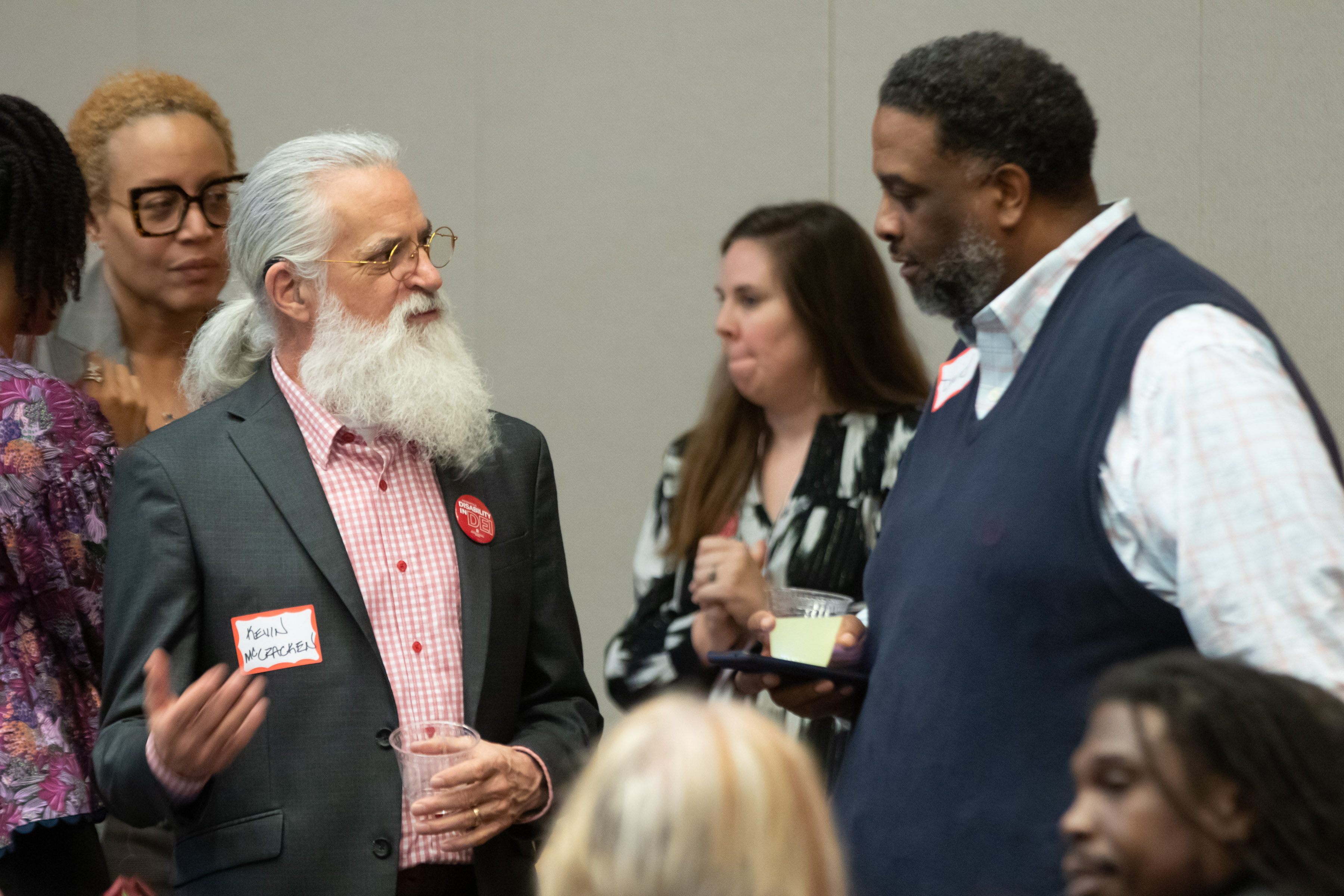 View of well dressed attendees engrossed in discussion