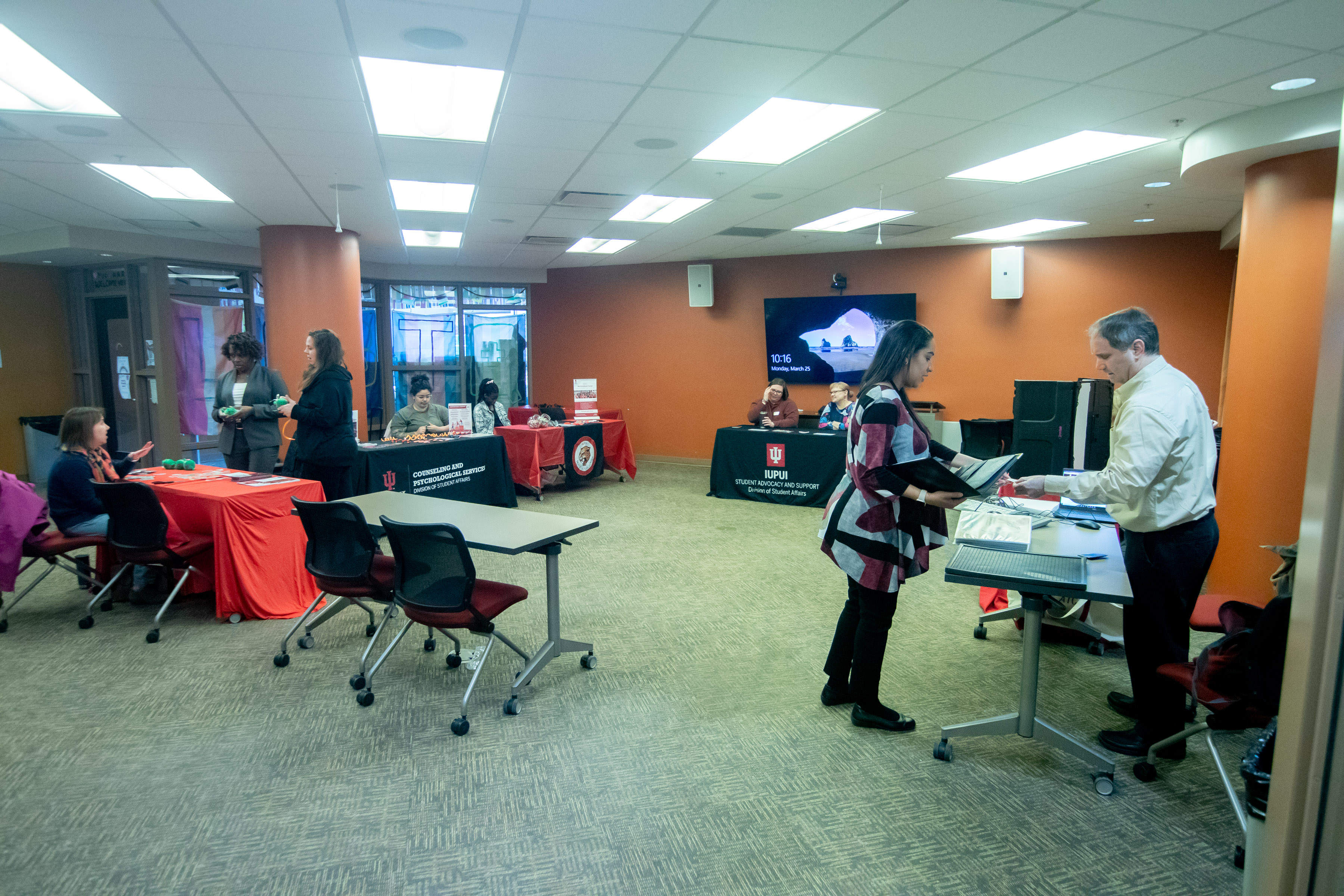 view of the resource fair with tables set up and attendees speaking to different resource representatives