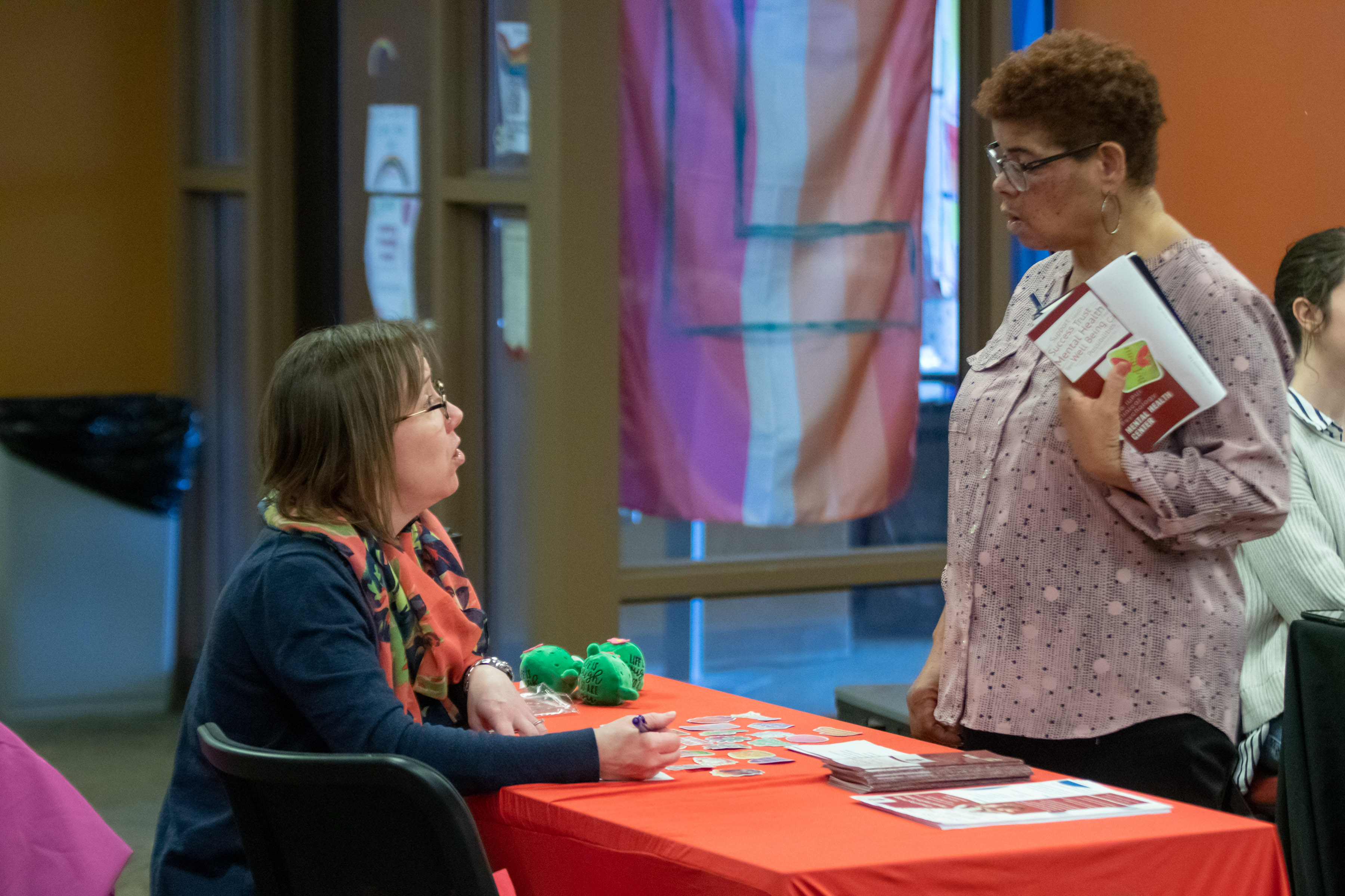 View of the Mental Health representative mid discussion with an attendee